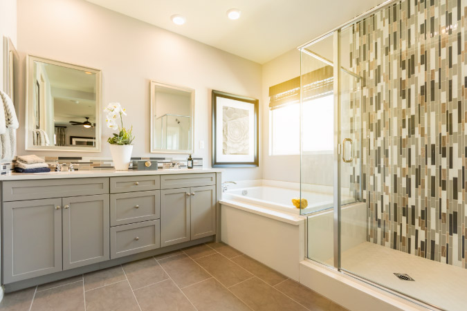 A large 10x10 bathroom featuring a shower, bathtub, double vanity, and plenty of floor space