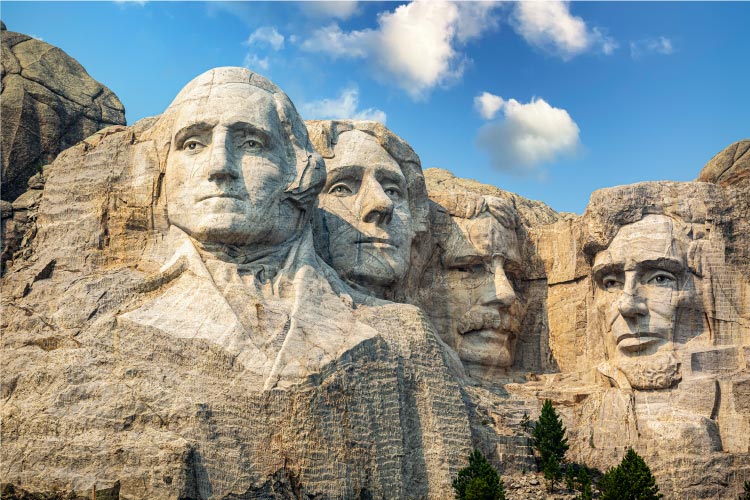 The Mount Rushmore monument is seen on a sunny day in Keystone, South Dakota. 