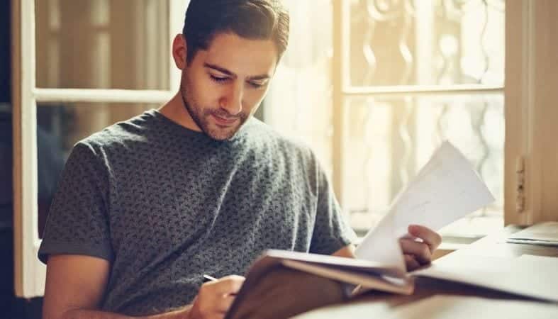 A man is figuring out his finances before tackling how to find roommates