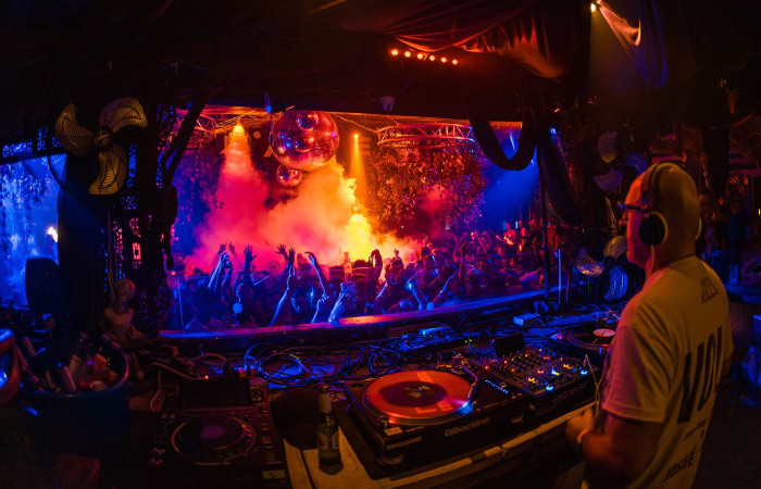 A DJ mixes music as the crowd in Club Space goes wild during a night out in Miami.