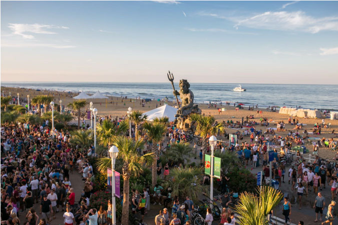 A crowd is gathered for a music event at Neptune’s Park in the Oceanfront neighborhood of Virginia Beach, Virginia