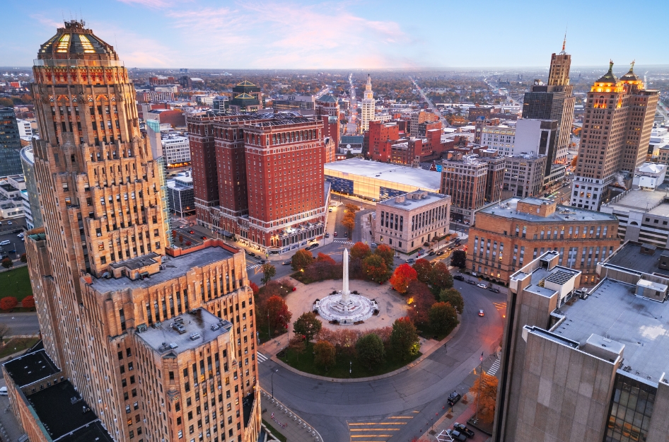 Aerial sunset view of the downtown skyline in Buffalo, showcasing vintage skyscrapers and highlighting the excitement of living in Buffalo, NY.