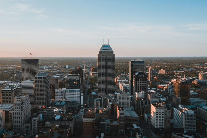 the skyline of Indianapolis, IN. Indiana is one of the best states to buy a house in right now.