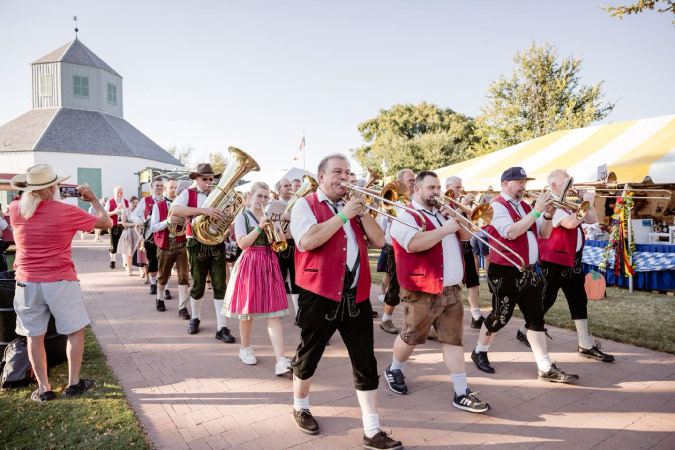 A local brass band in Fredericksburg — one of the best small towns in Texas — march in time as they perform during Oktoberfest