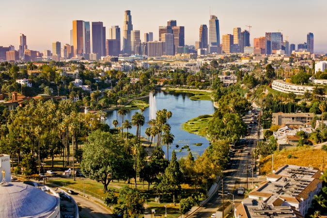 View of Echo Park Lake and the Downtown LA skyline in Echo Park — one of the best neighborhoods in Los Angeles.