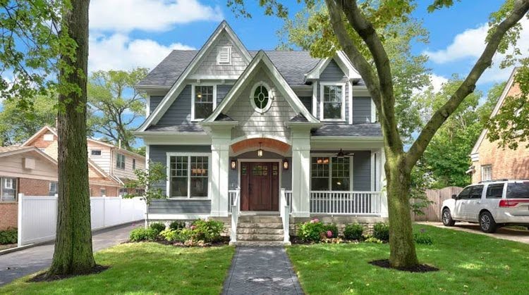 A two-story Victorian-style house with a shady front yard in Watkins Park — one of the nicest neighborhoods in Nashville.