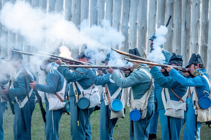 Several U.S. soldier reenactors in period uniform performing at Fort King National Historic Landmark, a key Army headquarters during the Seminole War.