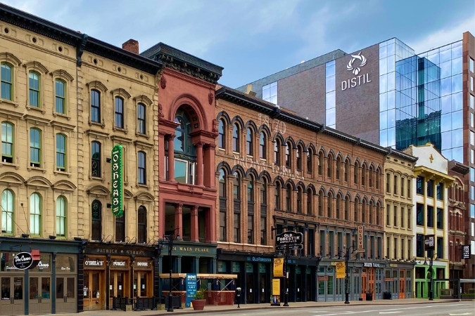 Bars, restaurants, and urban distilleries line Whiskey Row along Main Street in Louisville, KY.