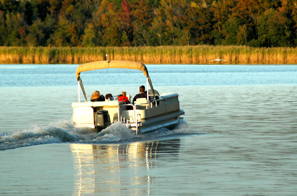 A family boats on a lake while living in Leesburg, FL.