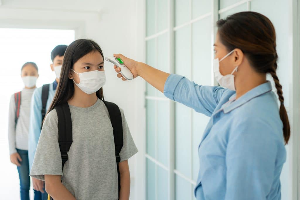 Students standing in line for a temperature check