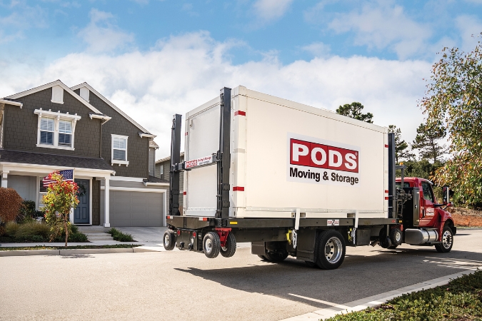 A PODS container loaded onto a truck in a residential neighborhood, ready for transport to the South Carolina coast.