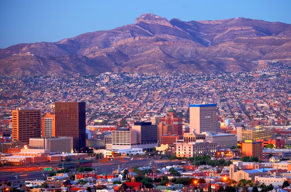 Late afternoon view of the city of El Paso, Texas, and surrounding El Paso neighborhoods with the mountains in the distance.
