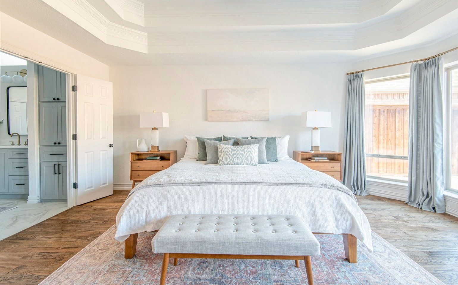 A bright, white, and blue bedroom