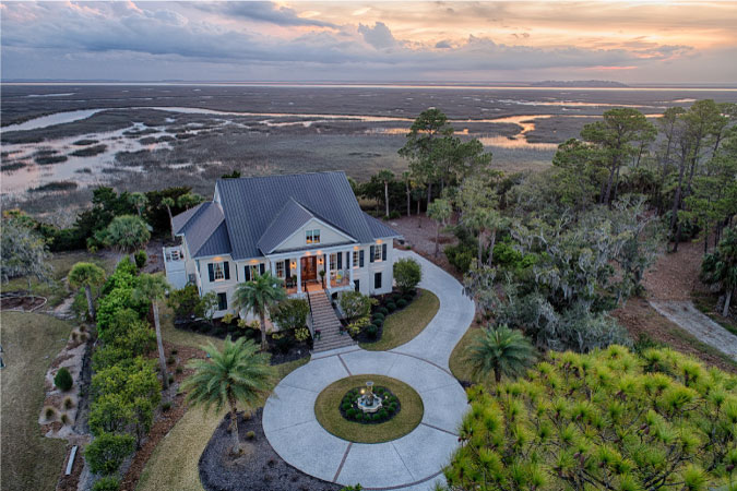 Aerial view of a large, luxury home on Skidaway Island in Savannah, GA, surrounded by the island’s natural beauty.