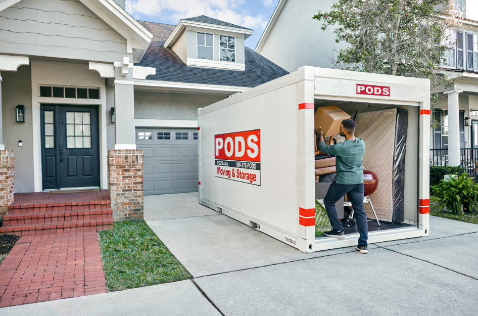 A young man loads his PODS portable storage container as he prepares to move by himself.
