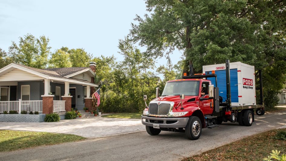 A PODS truck sits outside a military family's home as they prepare for their PCS move.