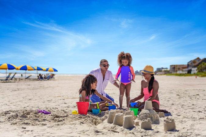 A family of four plays in the sand at Daytona Beach near Leesburg, Florida.