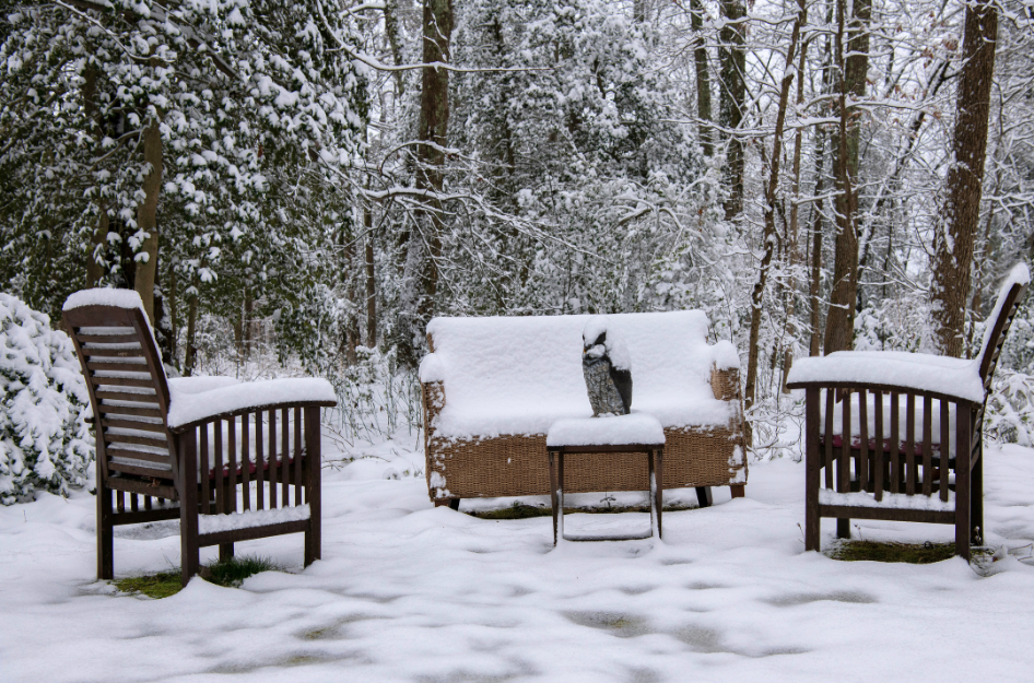 Snow covered furniture sits outside covered in snow. It could have been avoided by following proper winter storage tips.