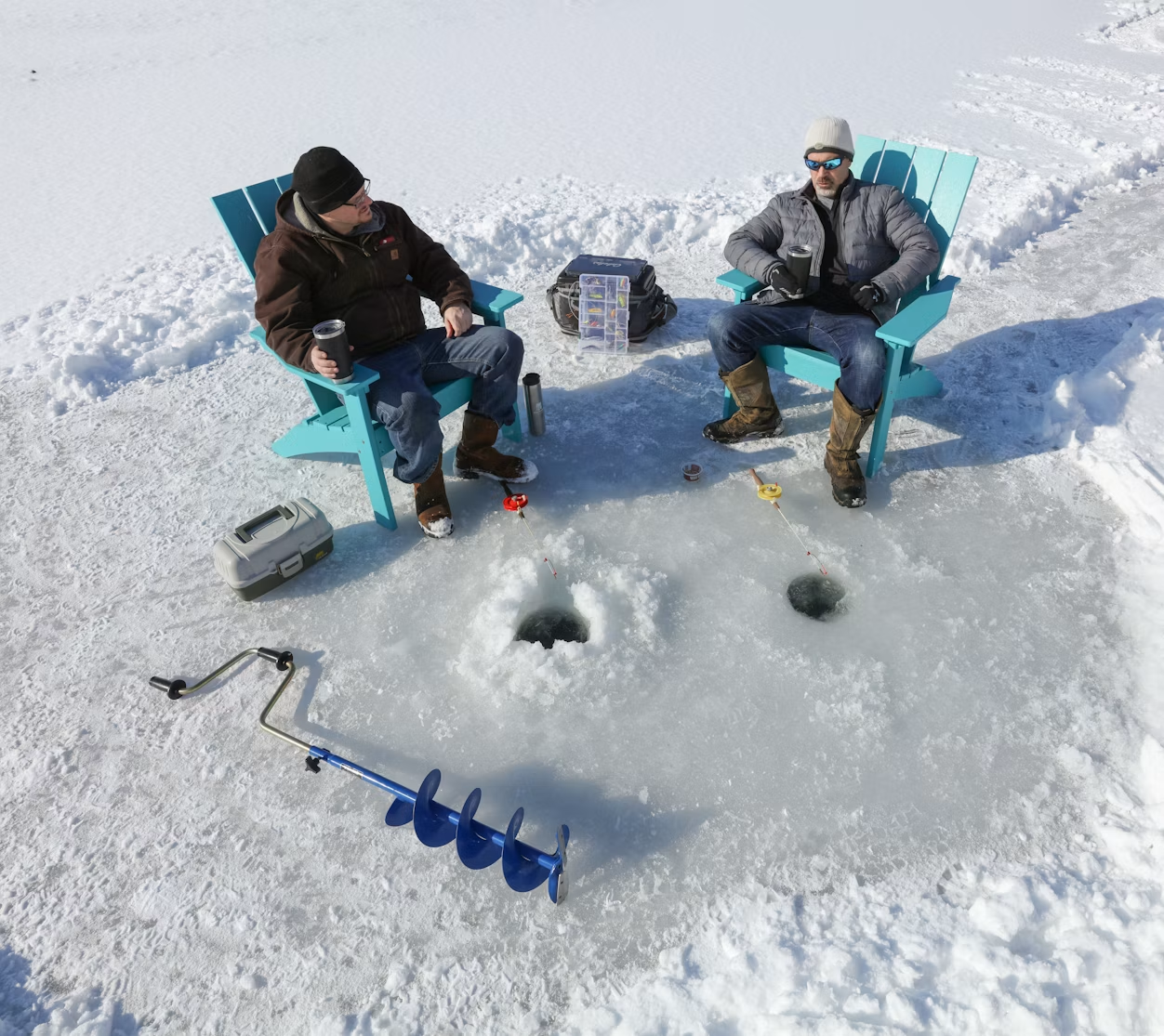Two men relax in plastic chairs on a frozen lake beside drilled-out fishing holes.