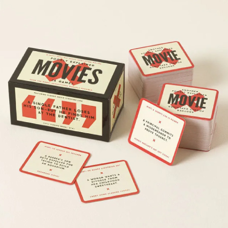 A card game box labeled “Poorly Explained Movies Game,” with a cream, red, and black design and two stacks of game cards.
