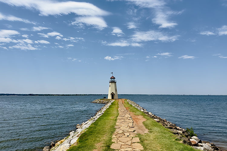 A lighthouse seen at the end of a jetty.