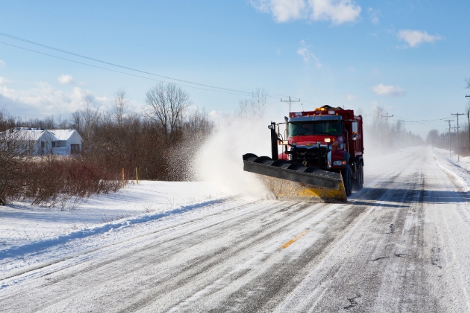 A snow plow clears a residential street after some wintry Buffalo weather.