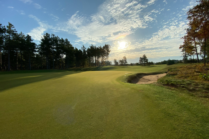 An image of an empty golf course on a sunny day.