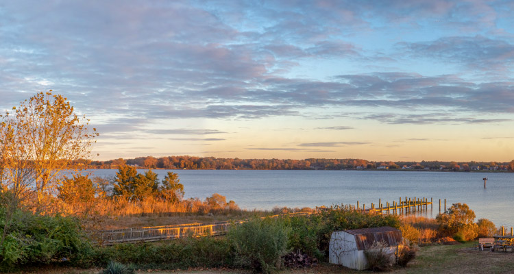 A waterfront view in Leonardtown, Maryland, during sunset.