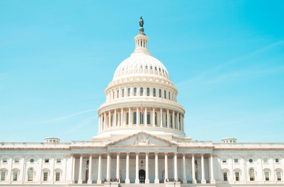 The United States Capitol shines brightly against a clear blue sky on a sunny day in Washington, DC.
