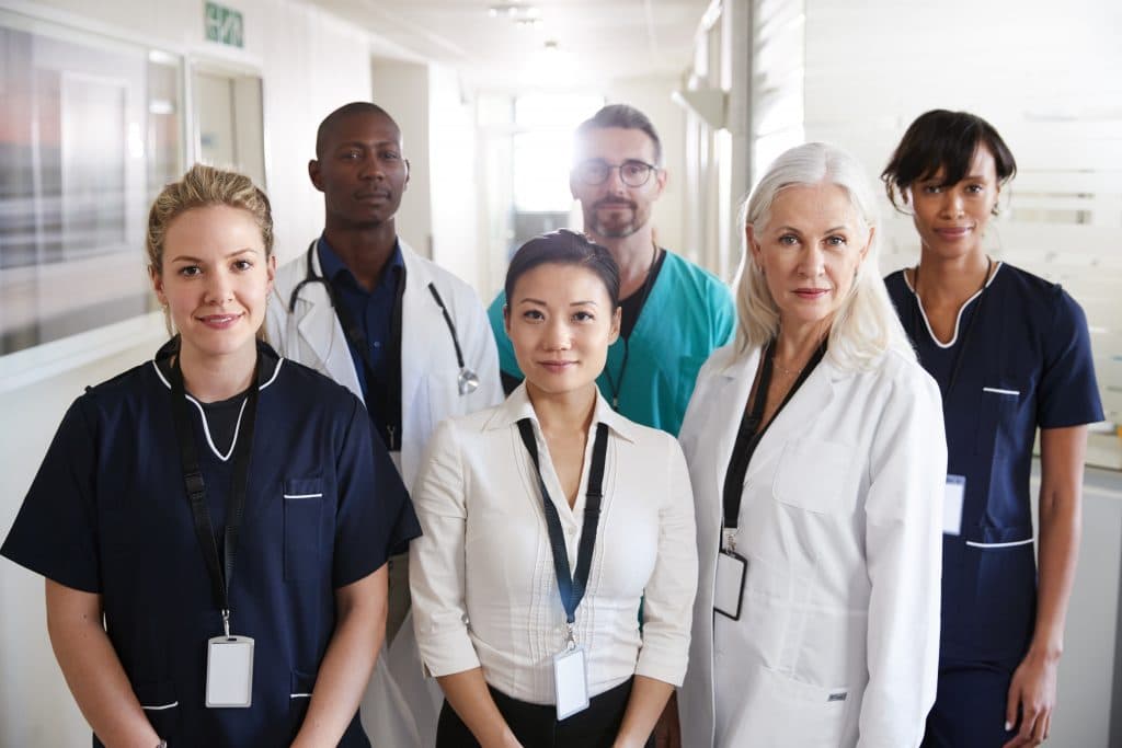 Various members of a medical team for public health emergencies standing inside a hospital