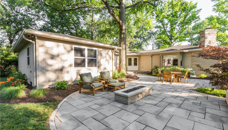 View of a one-story, mid-century home in Meridian Hills, Indiana, from the backyard.