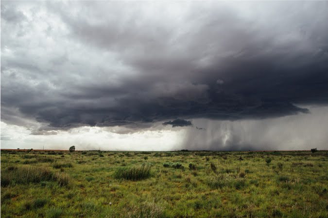 A thunderstorm passing over an open field in Texas.
