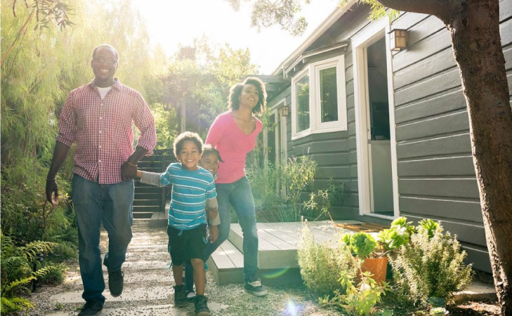 A family happily runs along the walkway beside an L.A. house that could potentially be their next home.
