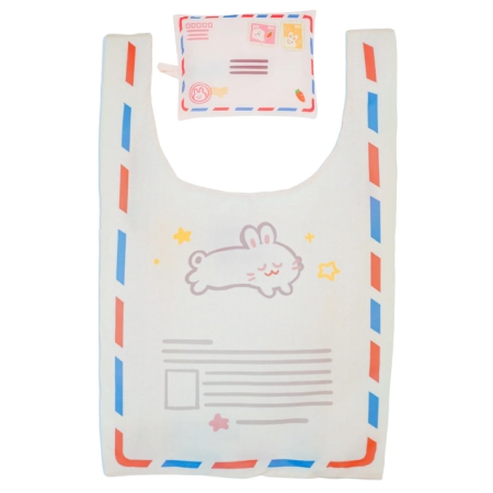 Front view of a cute reusable shopping bag with a matching carrying pouch, each with matching mail-themed and bunny decorations.