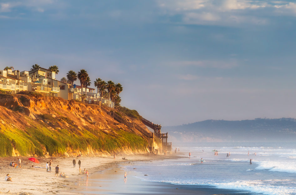 A sunny day has attracted dozens of locals to South Carlsbad State Beach in Carlsbad, California, for swimming, surfing, and sunbathing.
