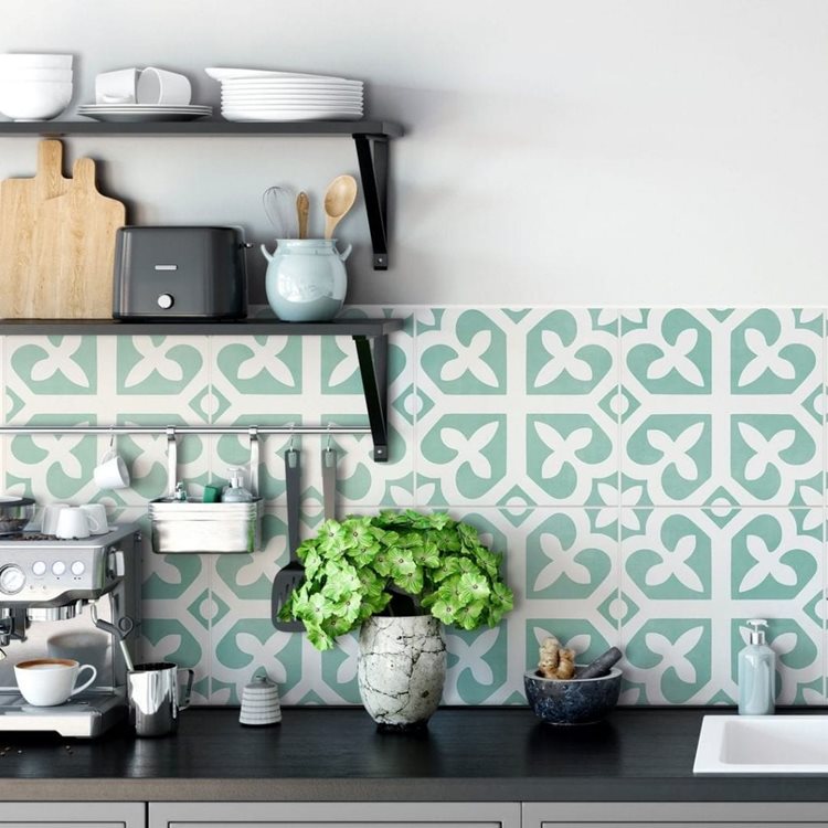 A portion of a kitchen counter looks brighter and newer after some small kitchen updates, including a new decorative teal backsplash.
