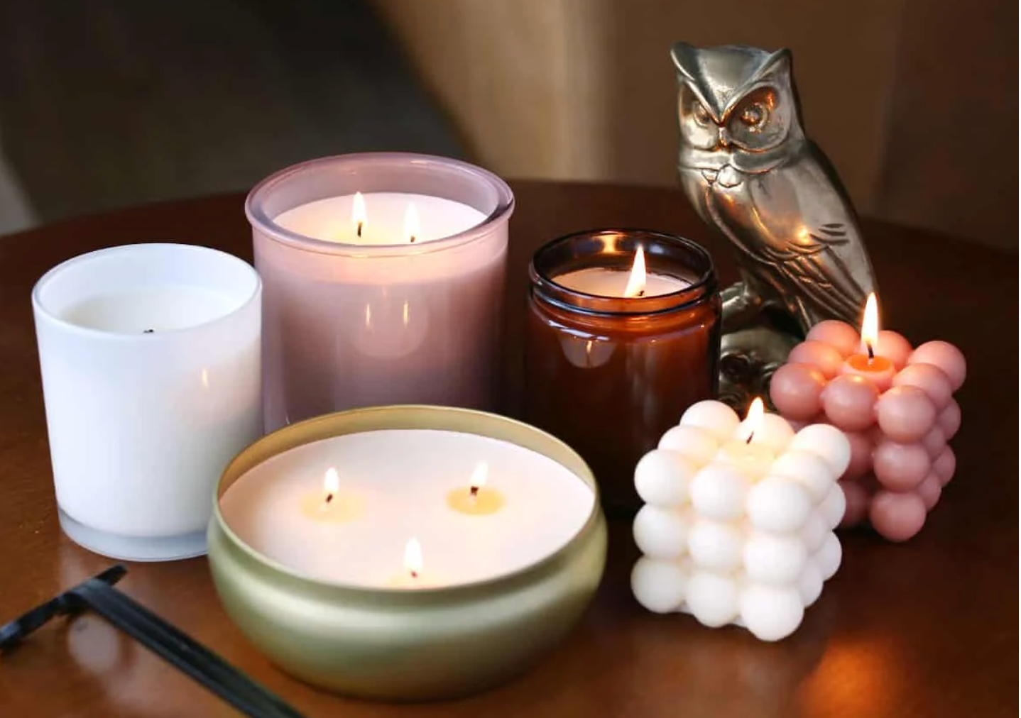 A collection of last-minute DIY Christmas gifts — specifically homemade candles — sits on a table.