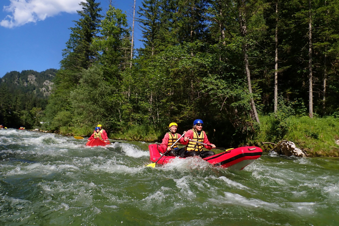 Three people rafting through the mountains while living in Durango, CO.