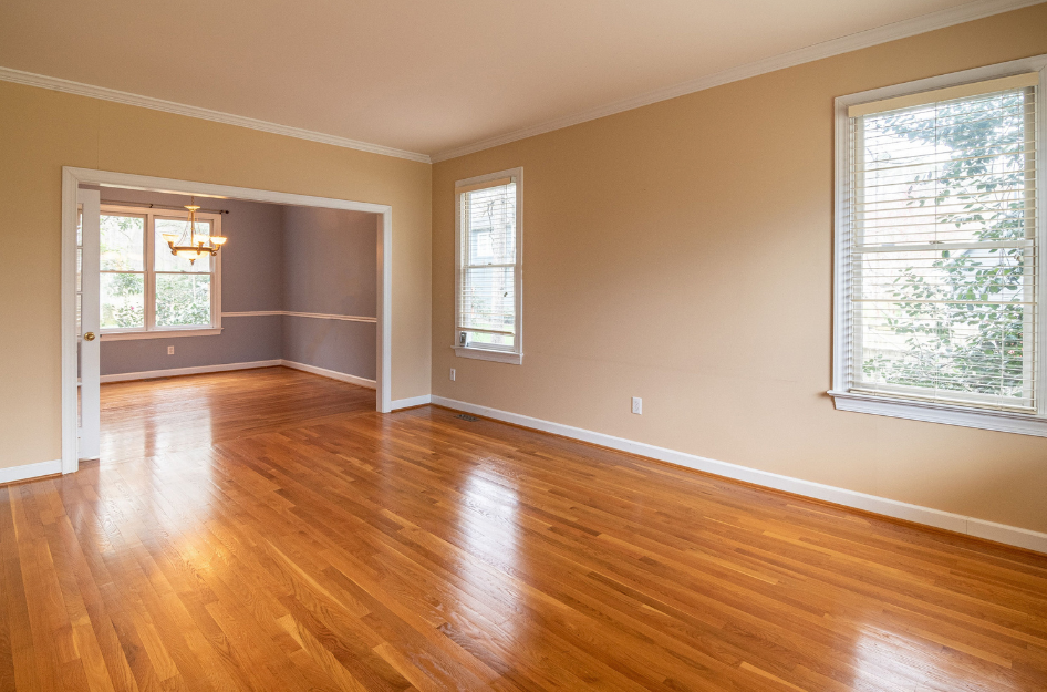 A brightly lit room with a new wood floor.