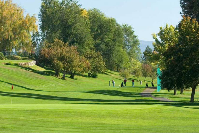 Golfers enjoy a sunny day playing on Downriver Golf Course in Audubon-Downriver — one of the best Spokane neighborhoods.