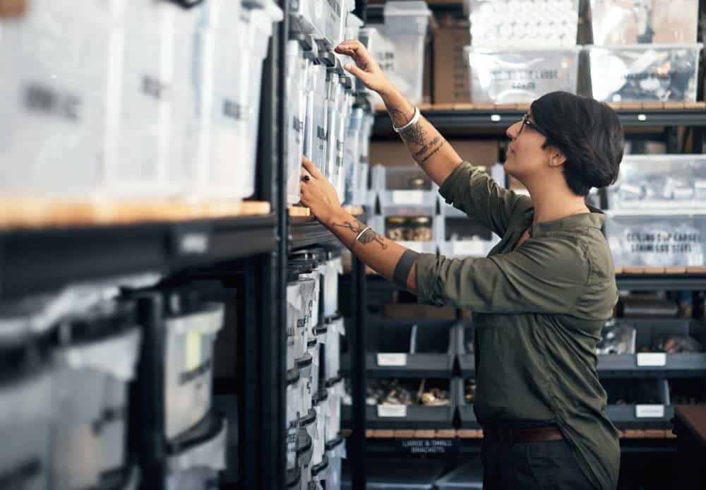 A shopper inspects plastic storage boxes