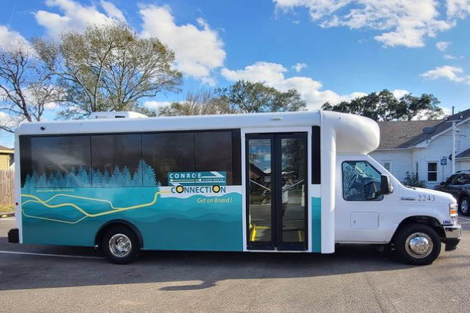 A Conroe Connection bus is stopped in a parking lot in Conroe, Texas.