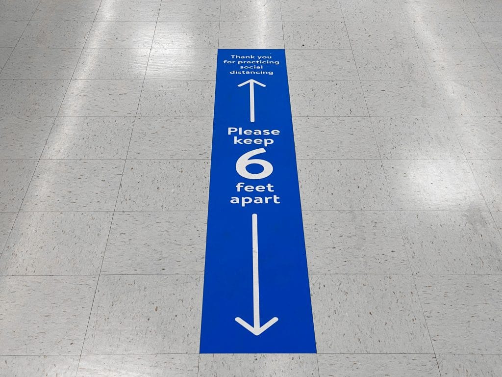 A social distancing foor decal on tile