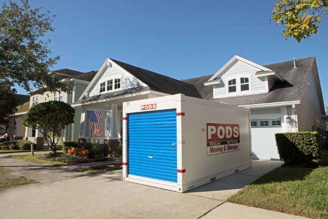 A PODS portable moving container is positioned in the residential driveway of someone who is now living in Fort Myers, Florida.