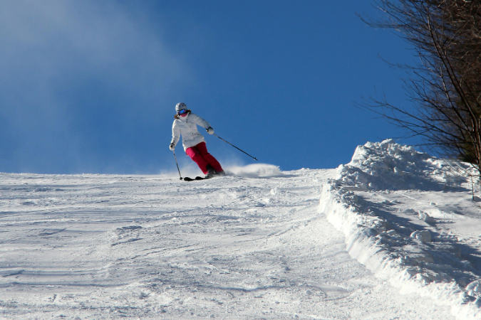 An image of a woman skiing on a bright day while living in Durango, CO.