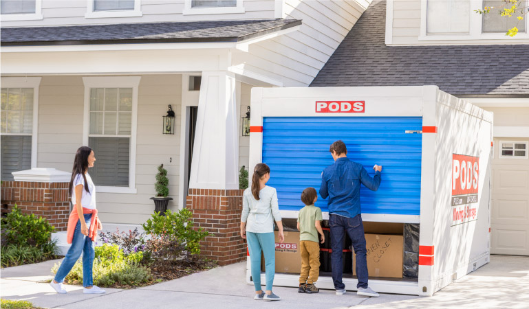 A family is getting ready to unload their PODS portable moving and storage container at their new Raleigh home. 