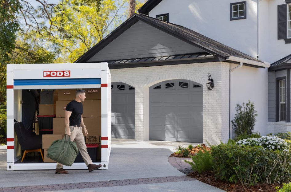 A service member unpacking a PODS container at home, after comparing Military movers and PPM options for a PCS.
