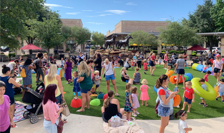 Local families enjoy a community event on a sunny day at LaCenterra in Cinco Ranch.