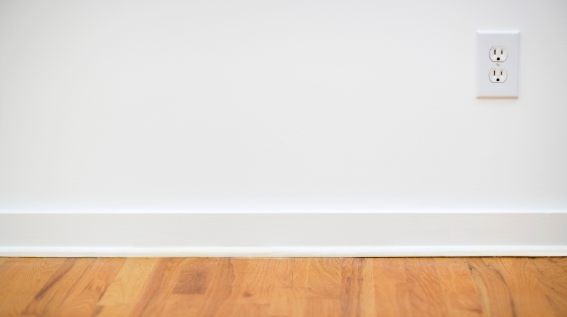 Floor-level view of an outlet with nothing plugged into it