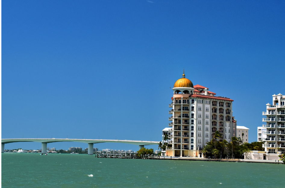 An image of a high rise hotel on the water in Sarasota, one of the best cities to live in Florida.